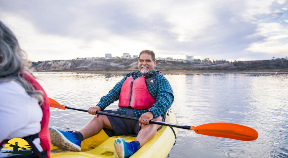 A heavy man sitting on a kayak