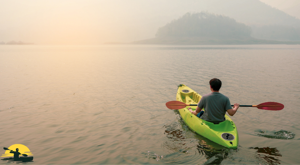 A man is kayaking in the sea