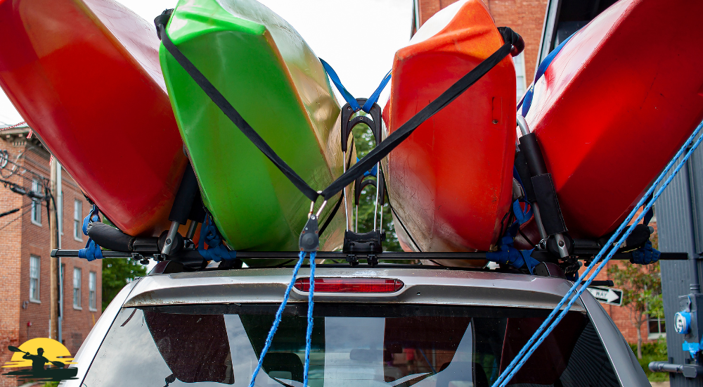 Four kayaks tieing up on the car