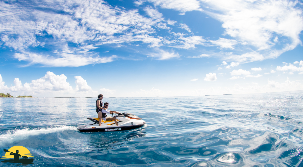 a man and a girl riding a jet ski
