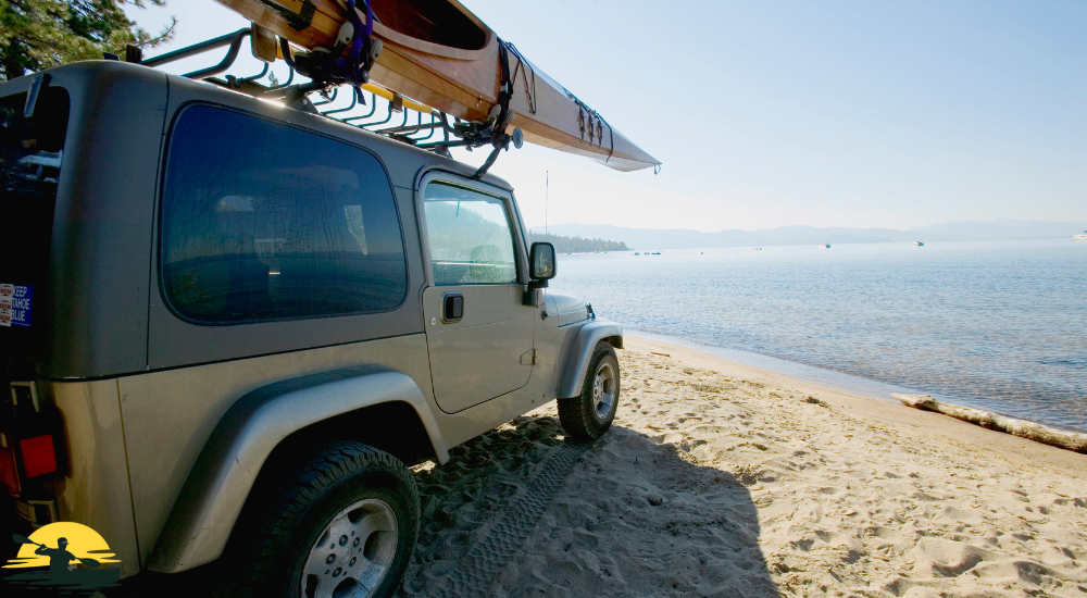 kayak and car in front of the beach 