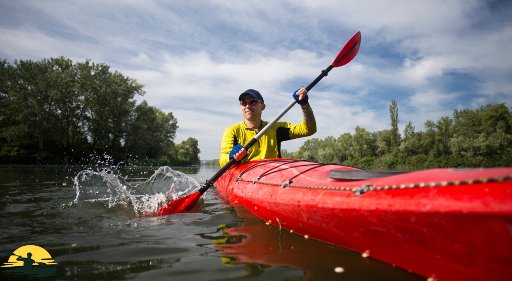 A man is kayaking in a lake