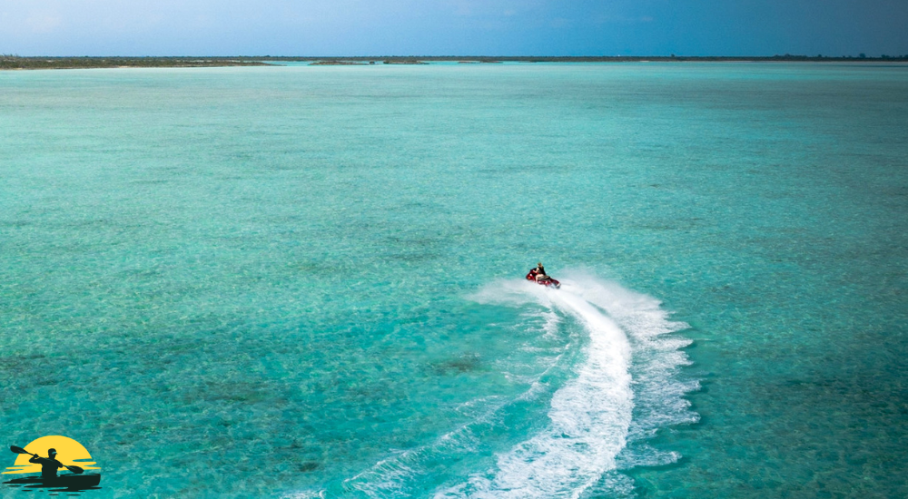 A man is riding a jet ski on the sea