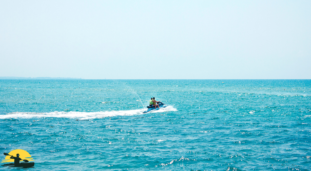 Two people are riding a jet ski into the sea