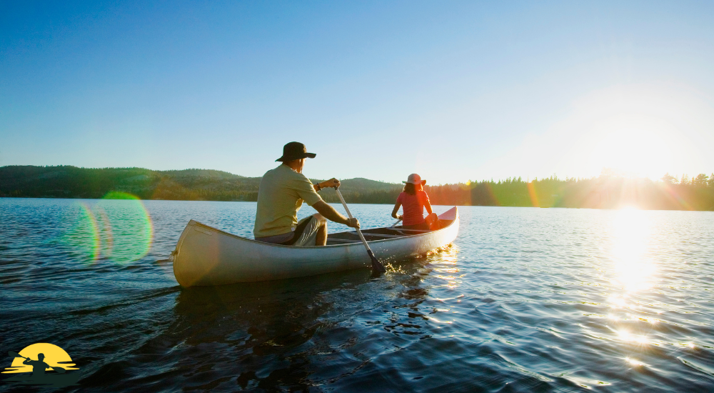 A man and lady are canoeing into the lake 