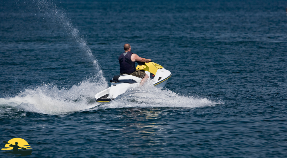 A man is riding a jet ski on the sea