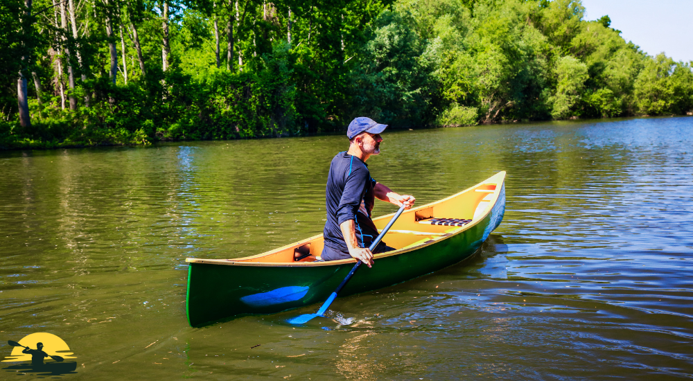 A man is driving a canoe