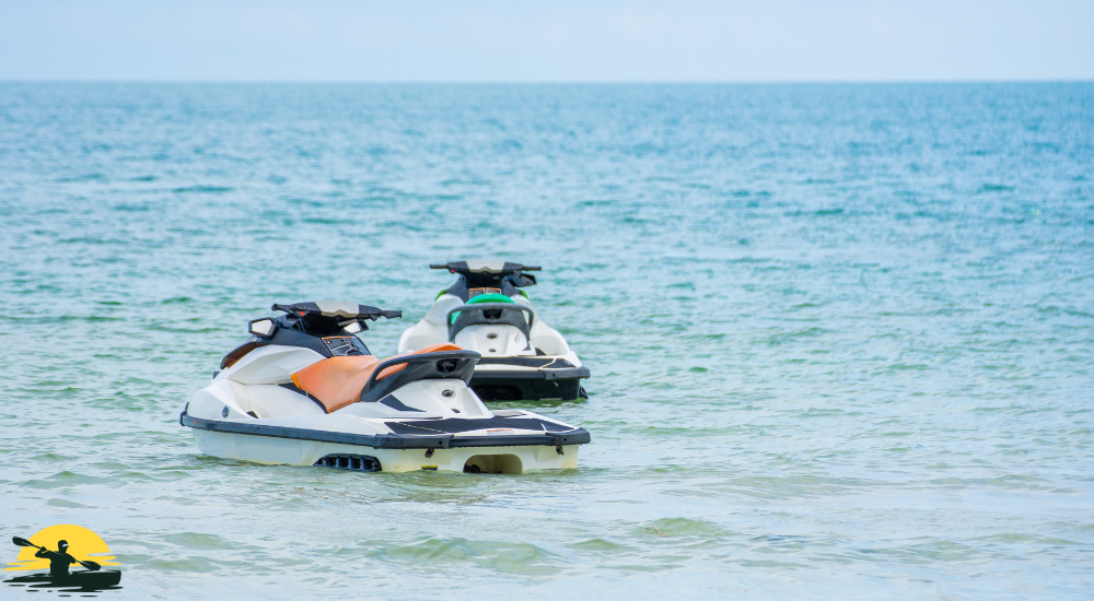 Two jet skis are on the water