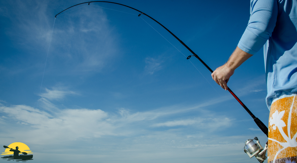 a man with a fishing pole in hand