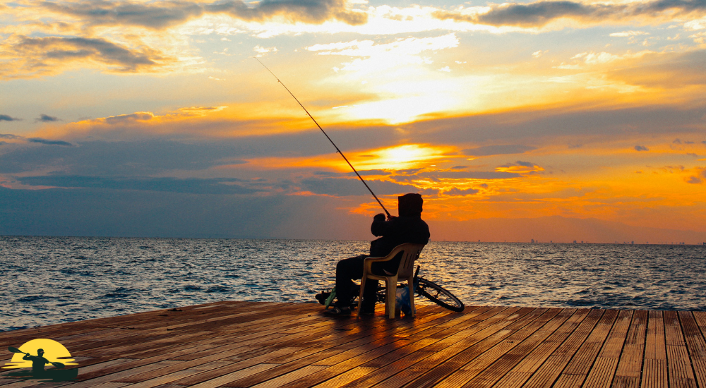 A man is fishing in the ocean side
