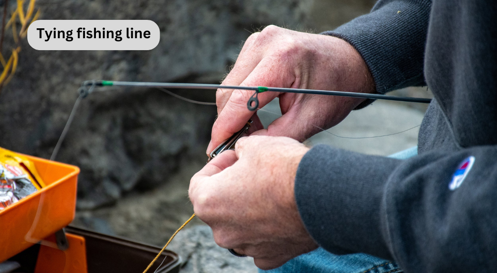 A man is tying fishing line with lure