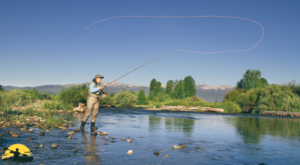 A lady is casting a fishing rod on a riverside