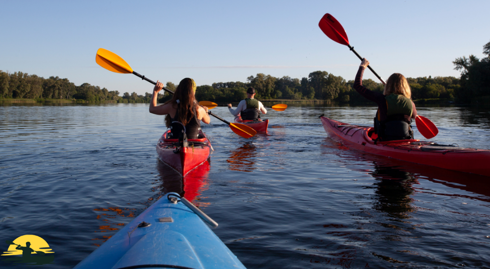 People are kayaking on a lake