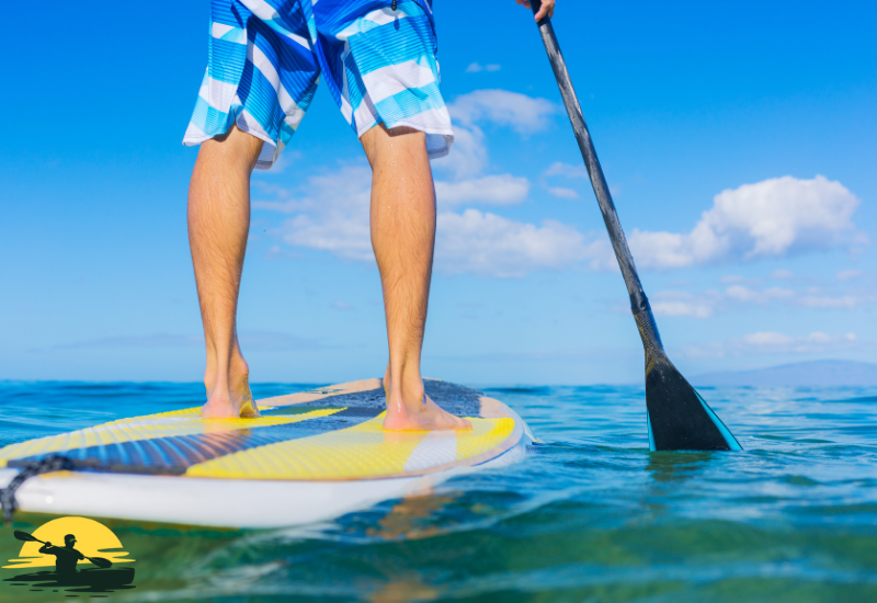 A man is paddling a board