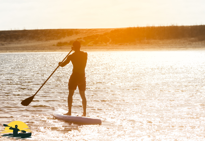 A man is paddling a board