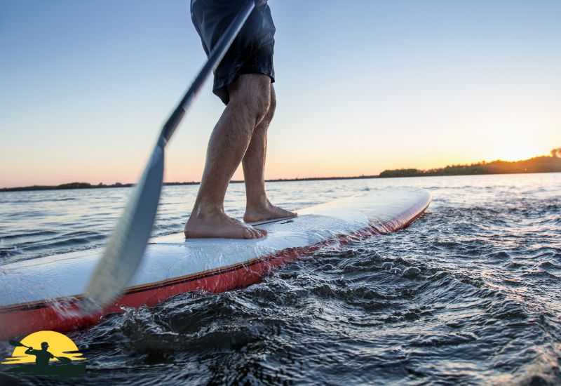 A man is paddling a board