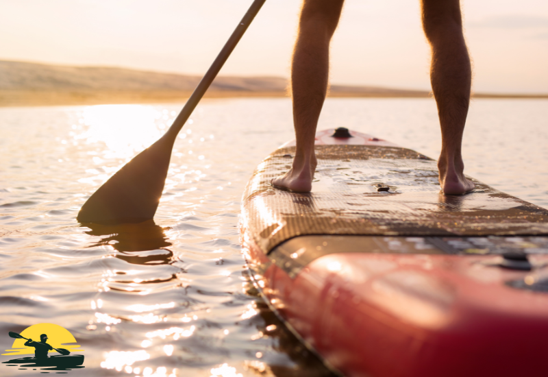 A man is paddling a  board